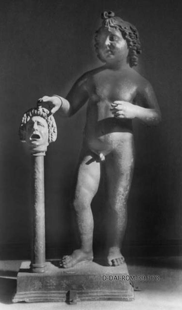 Villa dei Papiri, Herculaneum. Atrium. Bronze statue of cupid with right hand on mask found in 1754 round the impluvium.
DAIR 39.173. Photo © Deutsches Archäologisches Institut, Abteilung Rom, Arkiv.
Now in Naples Archaeological Museum. Inventory number 5030.